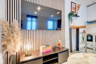 a room with a wooden accent wall with a desk at LIÉGE - Le cocon de Chênée in Chênée