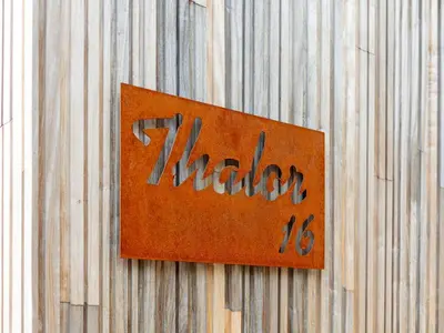 a sign on a wooden fence with the word hidden at Thalor in Zutendaal