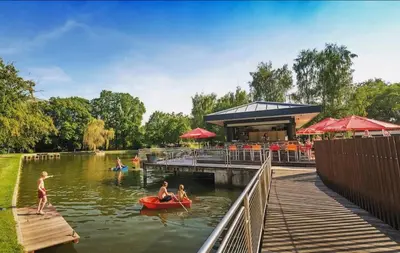 a group of people in the water at a park at pipowagen met prive Hot tub in Lanaken
