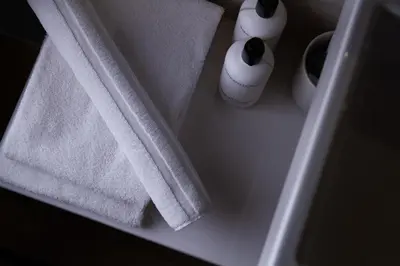 two towels and two vases sitting on a table at Hotel Het Menneke in Hasselt