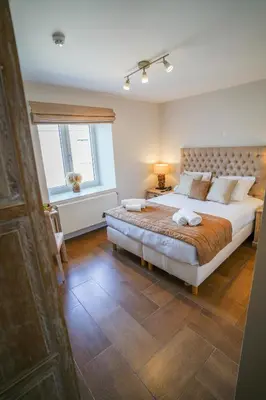 a bedroom with a large bed and a window at Hôtel Au Comte de Mercy in Oupeye
