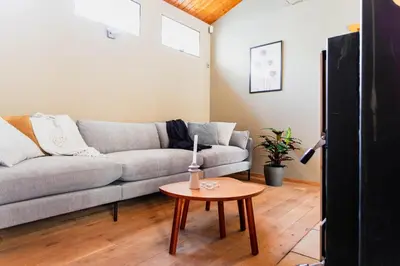 a living room with a couch and a table at 8P 4B Authentic house with playroom and infrared sauna in Bilzen