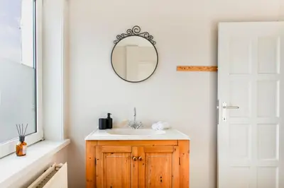 a bathroom with a sink and a mirror on a wall at 8P 4B Authentic house with playroom and infrared sauna in Bilzen