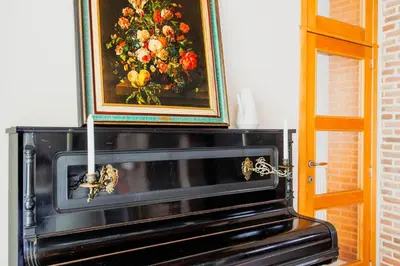a painting of flowers on top of a fireplace at 8P 4B Authentic house with playroom and infrared sauna in Bilzen