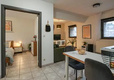 a living room with a table and a living room at De Millenniumhoeve (Jean) in Riemst