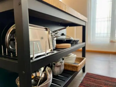 a kitchen with a shelf with pots and pans at Art Loft -Opéra, Saint-Lambert, Bueren in Liège