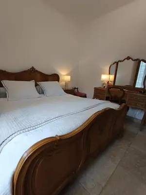 a bedroom with a large wooden bed and a mirror at Sleep and Dream in Liège