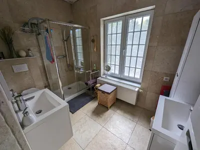 a bathroom with a shower and a sink and a tub at Sleep and Dream in Liège