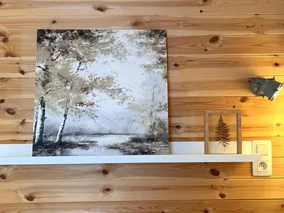 a picture hanging on a wooden wall with a shelf at Chalet Wielsmer in Zutendaal