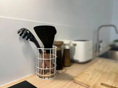 a group of utensils in a holder on a kitchen counter at L'escapade chic - Cathédrale, Saint Lambert in Liège