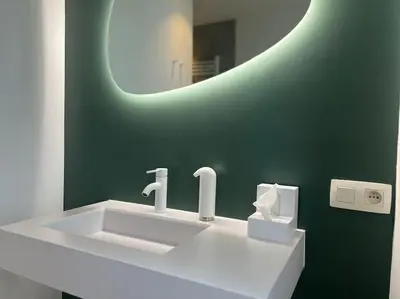 a bathroom with a white sink and a mirror at Duplex chic et spacieux - Hypercentre in Liège