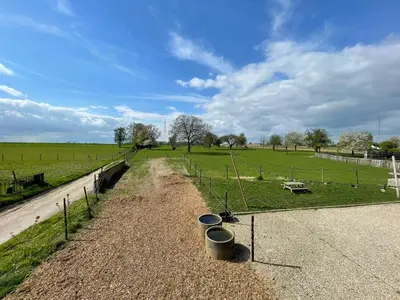 a dirt road with buckets on the side of a field at Boven de paarden @ de Hoeveschuur in Riemst