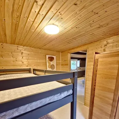a wooden room with two bunk beds in it at Cozychalet met prive Hot tub in Lanaken
