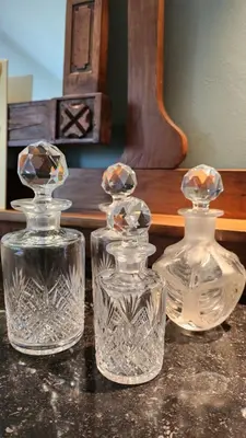 three glass bottles sitting on top of a table at Superbe loft de caractère avec garage à 10' du centre in Liège