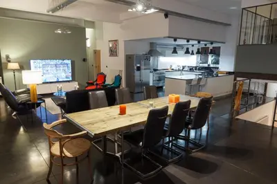a dining room and kitchen with a table and chairs at Superbe loft de caractère avec garage à 10' du centre in Liège