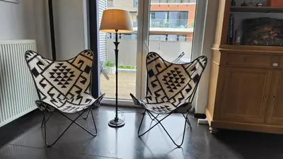 two chairs and a lamp in a living room at Superbe loft de caractère avec garage à 10' du centre in Liège