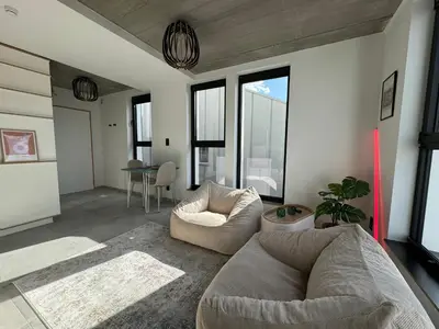 a living room with a couch and a table at PentHouse 5.01 in Liège