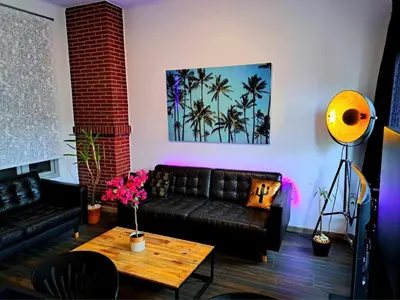a living room with a couch and a table at chambre avec 2 lits séparé dans une maison l'hote in Liège