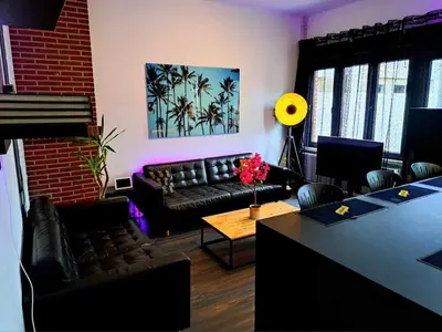 a living room with a couch and a table at chambre avec 2 lits séparé dans une maison l'hote in Liège