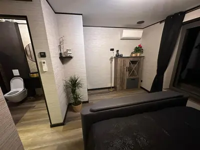 a bathroom with a couch and a toilet in a room at Tranquilo Maaseik in Maaseik