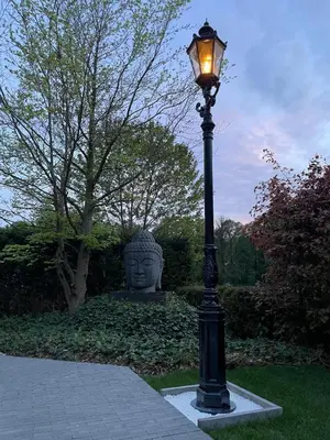 a street light with a statue in the background at Tranquilo Maaseik in Maaseik