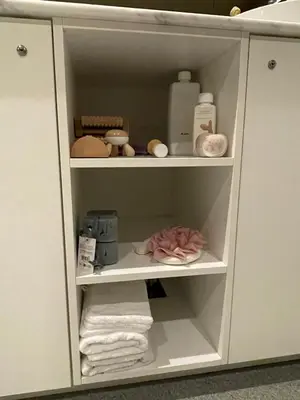 a white cabinet with towels and other items in it at Tranquilo Maaseik in Maaseik