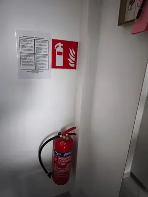 a fire hydrant in a white wall with a sign at Modern Lux studio in Beringen
