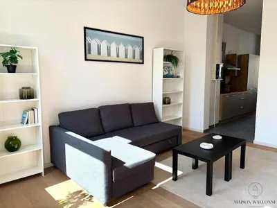 a living room with a couch and a table at Le Botanique des Augustins -100m2 en plein centre in Liège