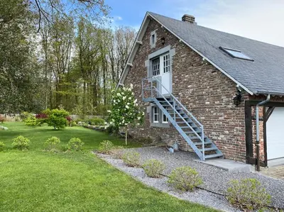 a brick house with a staircase leading up to a window at La réserve by la Villa KerKus in Fraipont