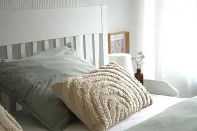 a bedroom with a bed with a pillow on it at Stijlvol App in Genk Centrum in Genk