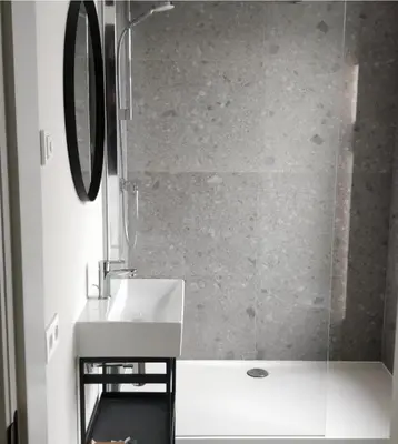 a bathroom with a sink and a glass shower at Het Maashuis in Maasmechelen