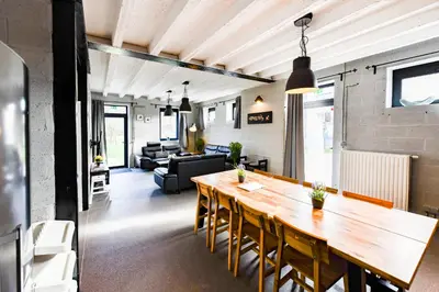 a living room with a wooden table and a couch at Smishoeve 