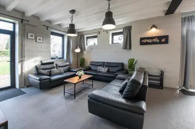 a living room with leather couches and a table at Smishoeve 