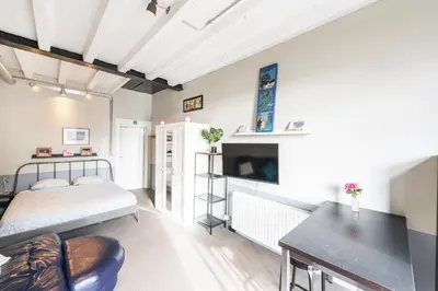 a bedroom with a bed and a desk in a room at 