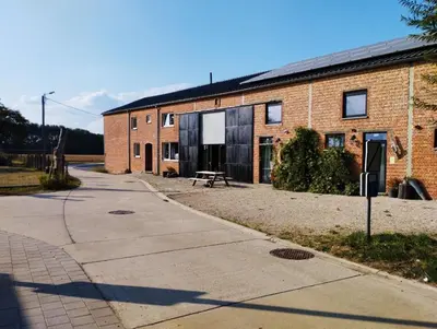 a brick building with a picnic table in front of it at 