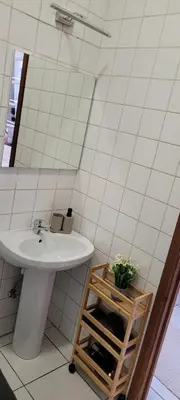 a bathroom with a sink and a mirror at Au coeur du théâtre in Verviers
