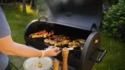 a person is cooking food on a grill at Vakantievilla 't Boshuys in Lommel
