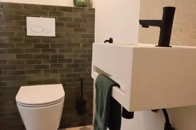 a bathroom with a toilet and a sink at Maas & Me in Dilsen-Stokkem