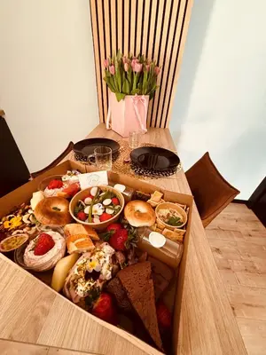 a box filled with different types of food on a table at Home Sweet House in Hermée