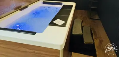 a table with a laptop sitting on top of it at Home Sweet House in Hermée