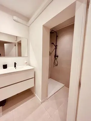 a white bathroom with a sink and a shower at Cosy Of John Cockerill 2 in Seraing