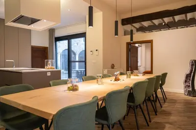 a conference room with a long table and chairs at De Droomhoeve in Bilzen