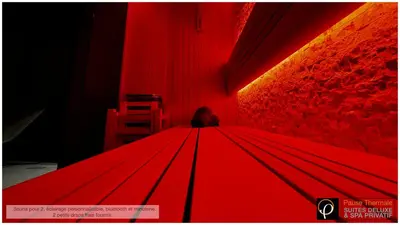 a person sitting on top of a red umbrella at Pause Thermale Suites Deluxe et Spa Privatif in Herstal