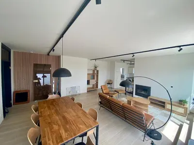 a living room with a table and a couch at Skylodgenk in Genk