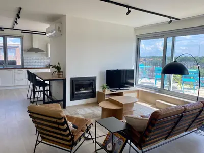 a living room with a couch and a fireplace at Skylodgenk in Genk