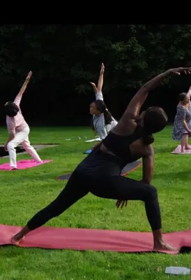 a group of people doing yoga in a park at Villa kleinwellness in Lanaken