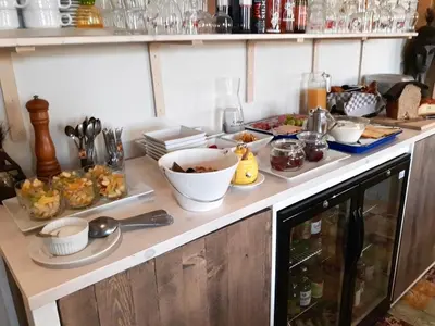 a kitchen counter with bowls and plates of food on it at B&B Horpala in Heers
