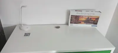 a newspaper sitting on top of a white refrigerator at Chambre R0 avec salle de bain partagée près de l'hôpital de la Citadelle à Liège in Liège