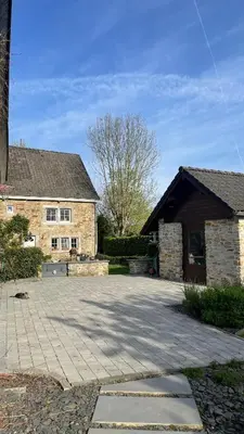 a brick house with a driveway in front of it at GP - F1 FRANCORCHAMPS - 2 Chambres in Trooz