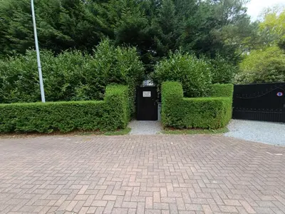 a park with two bushes with a trashcan in the middle at Just for sleep in Liège